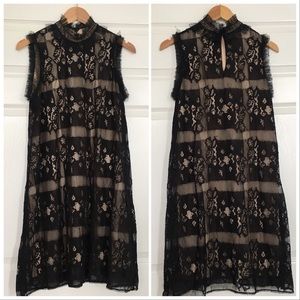 Sleeveless, high neck black and cream dress